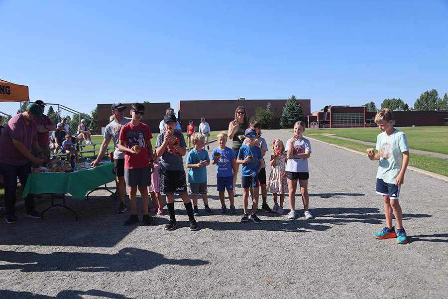 Manic kids eating donuts (doughnuts) before their 1 mile race at Webber school in Fort Collins