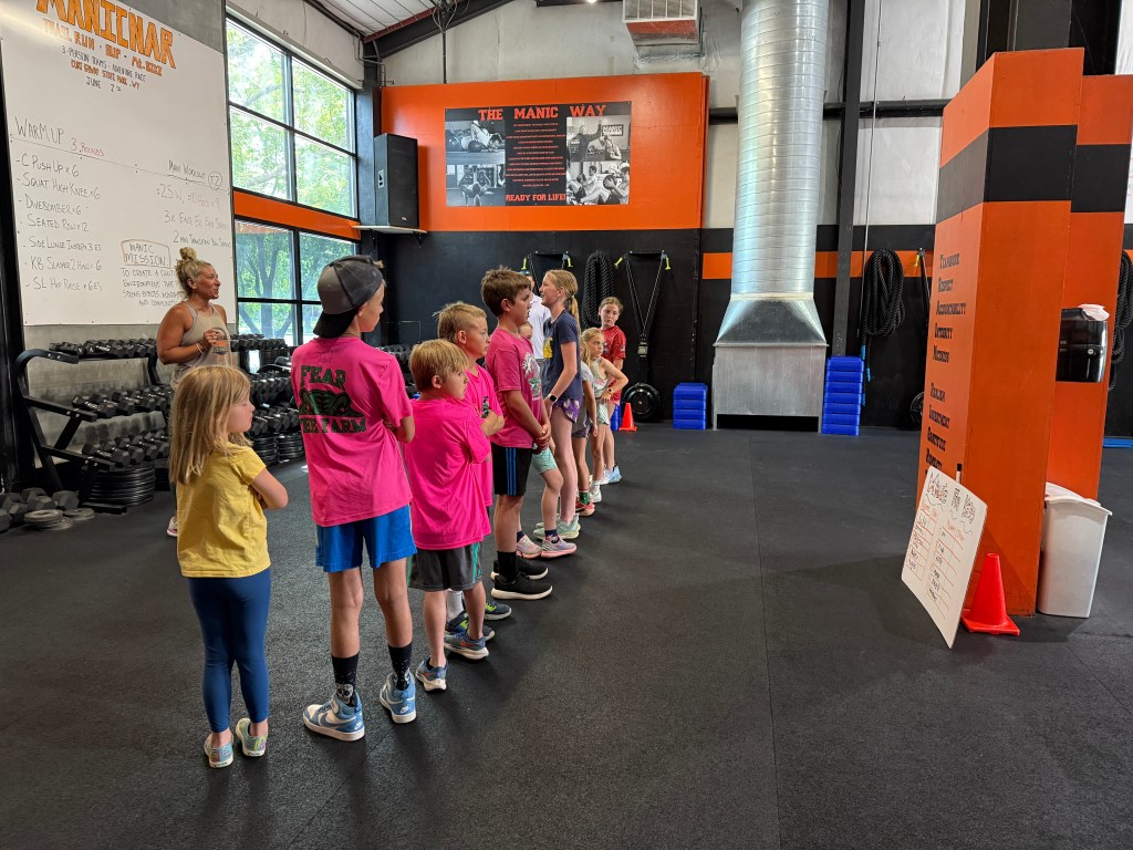 Manic Training FoCo kids standing in getting ready for class.