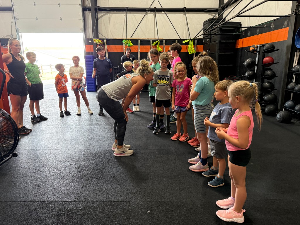 Manic Training kids Coach Pam Gundlach preparing the kids before their workout class