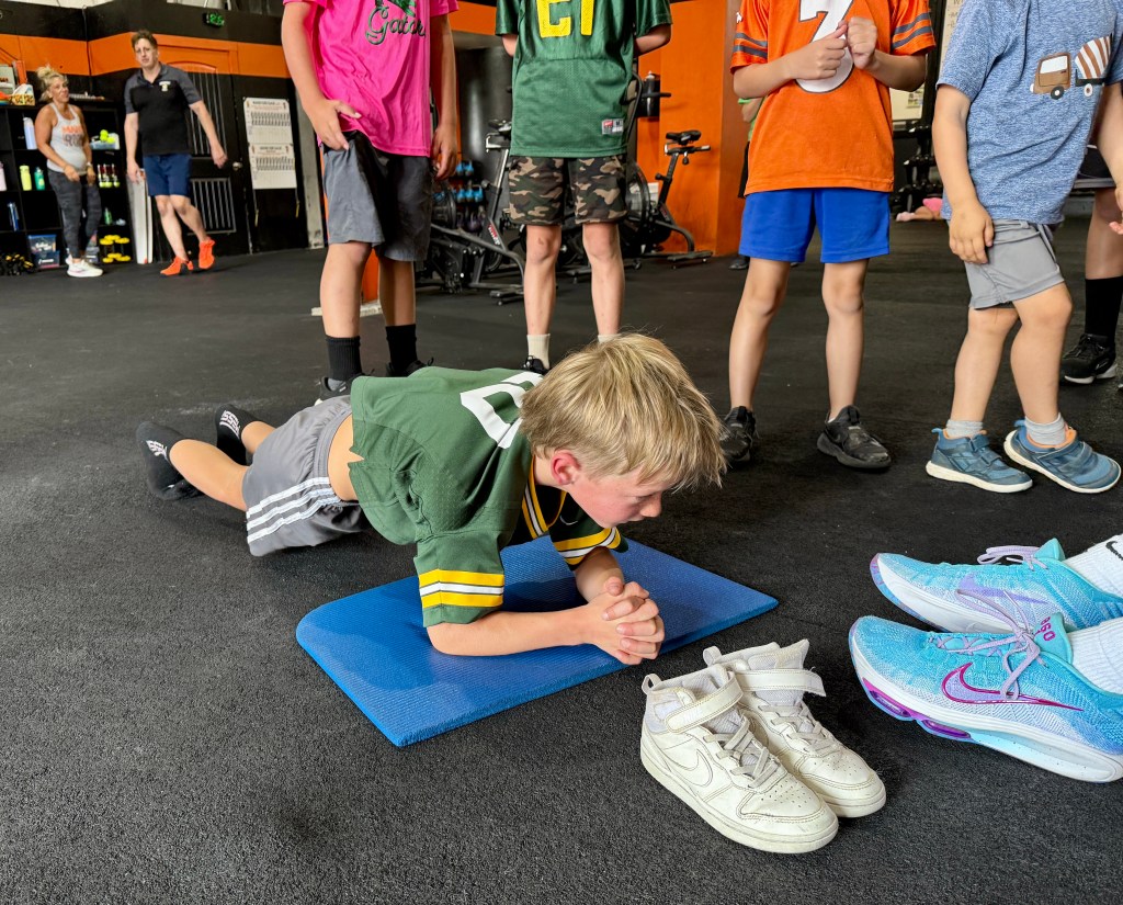 Manic Training kid holding a very long plank
