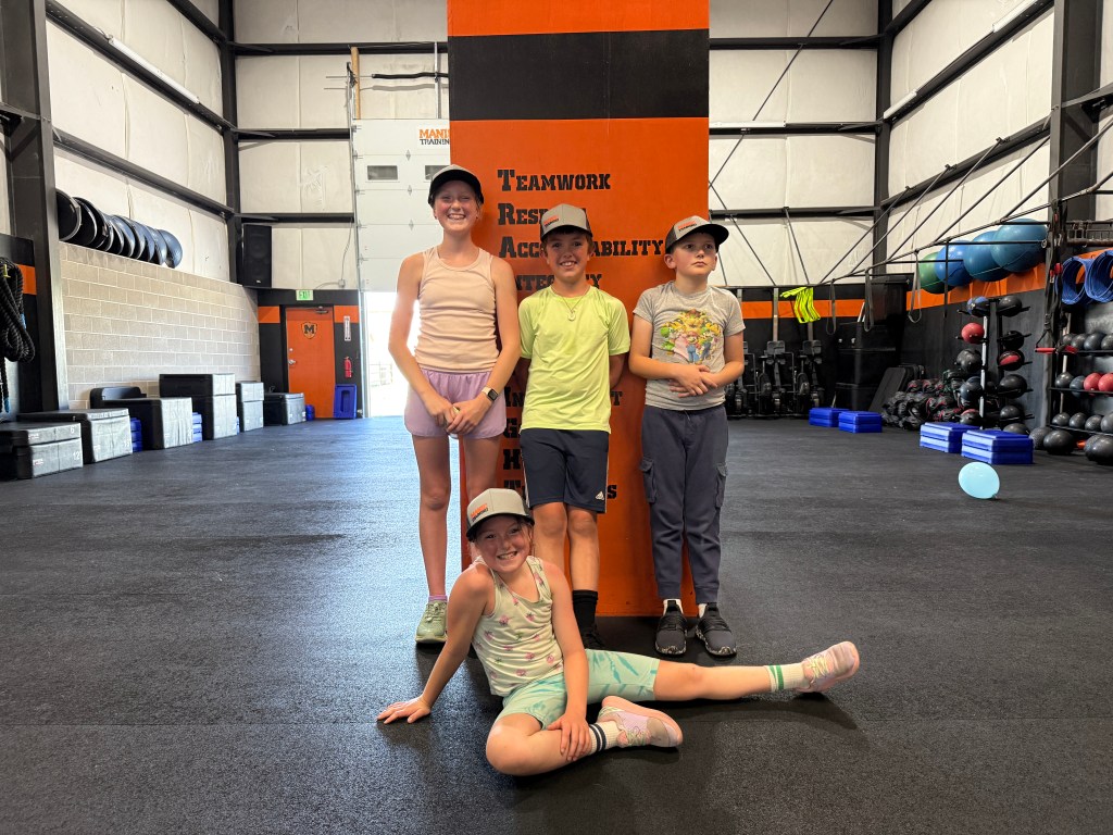 Manic Training FoCo kids striking a pose in front of our Manic ideals and philosophy